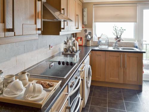 a kitchen with a sink and a stove top oven at Llys Aled in Llanedwen