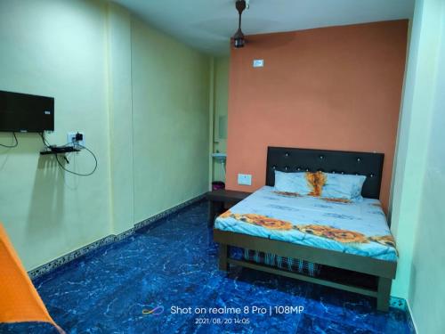 una camera da letto con un letto con un pavimento blu di Shree Vighnaharta Cottage ad Alibaug