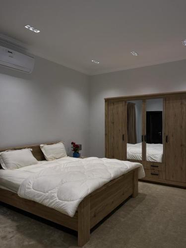 a bedroom with a large bed and a large mirror at Oxygen hatta in Hatta