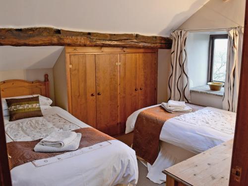 a bedroom with two beds and a window at Higher Paradise in Gisburn