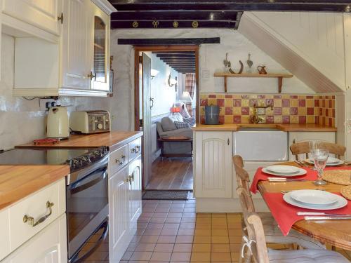 a kitchen with a table and a dining room at Y Teras in Rosebush