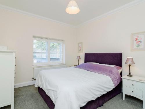 a white bedroom with a large bed and a window at Owls Croft - 27898 in Broadstairs