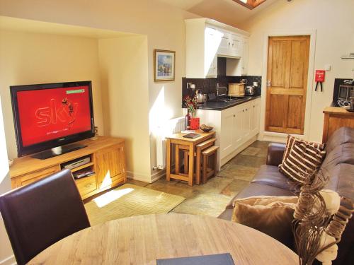 A television and/or entertainment centre at Old Brewery Cottage - S4576