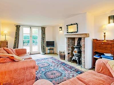 a living room with a couch and a fireplace at Holy Boys - 17626 in Castle Acre