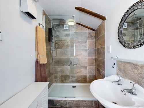 a bathroom with a tub and a sink and a shower at The Old Coach House in Iddesleigh