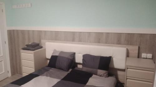 a bedroom with a bed with two pillows at ARCHETYP in Torrejón de Ardoz