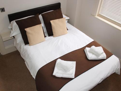 a large bed with two pillows on top of it at Apartment 2 in Filey