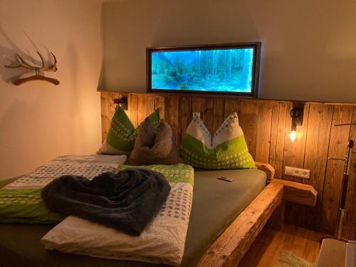 a bedroom with two beds and a tv on the wall at Ferienhaus Gruber in Aich