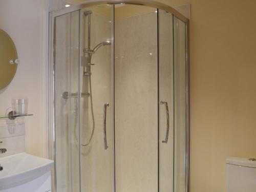 a shower with a glass door in a bathroom at The Old Dairy in Normanton on Trent