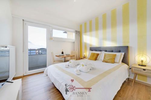 a bedroom with a large bed and a large window at Sunny Suite Nordic - Lugano City -By EasyLife Swiss in Lugano