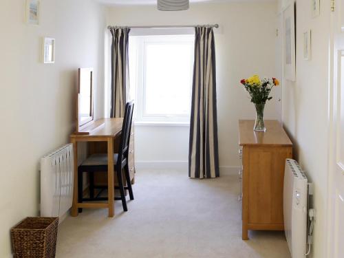 a home office with a desk and a window at Manor Cottage in Crantock