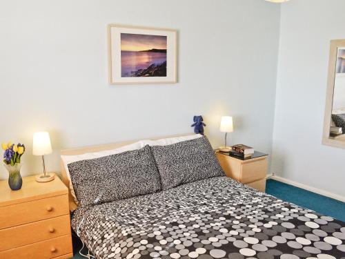 a bedroom with a bed and two night stands at Natterjack Cottage in Haverigg