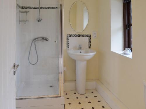 biała łazienka z umywalką i prysznicem w obiekcie The Cart Shed w mieście High Halstow