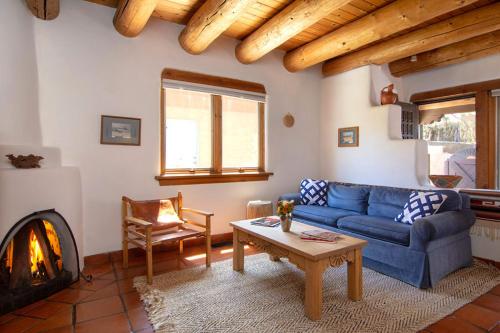 a living room with a blue couch and a fireplace at Las Brisas de Santa fe in Santa Fe