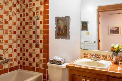 a bathroom with a toilet and a sink and a tub at Las Brisas de Santa fe in Santa Fe