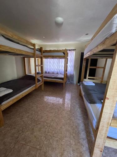 a room with three bunk beds in it at Wing Camp in Cabarete