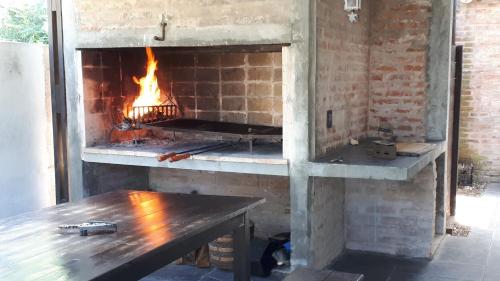 a brick oven with a fire in it at Milopotas in Punta del Este