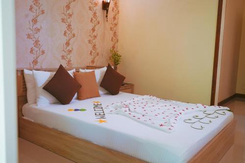 a large white bed with a happy new year sign on it at Banyan Villa Maldives Dhangethi in Dhangethi