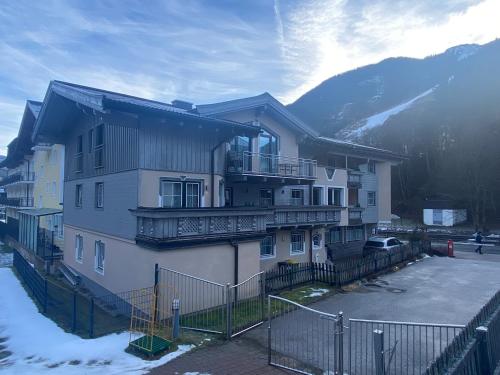 a apartment building with a balcony and a parking lot at Haus Eder Steiner in Saalbach Hinterglemm