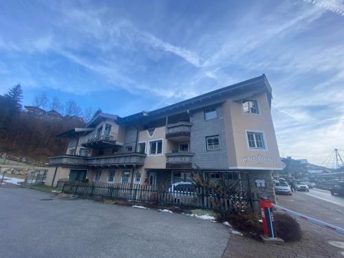 a large building with a fence in front of it at Haus Eder Steiner in Saalbach Hinterglemm