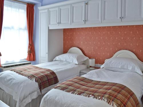 two beds sitting next to each other in a bedroom at Mere View in Ambleside