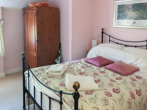 a bedroom with a bed with two pillows on it at The Creamery in Kniveton