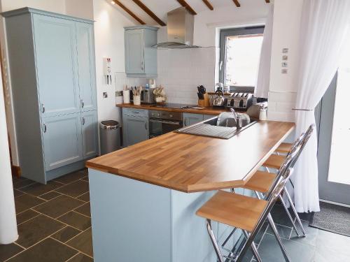 a kitchen with a sink and a counter top at Beach Bay Cottage in Mangersta