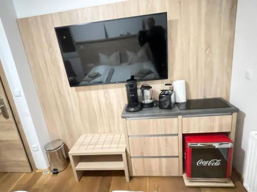 a bedroom with a tv on a wall with a bed at Luxury Apartment Monte Carlo in Pörtschach am Wörthersee
