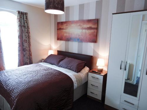 a bedroom with a bed and a painting on the wall at 3 Eldin Hall Properties in Cayton