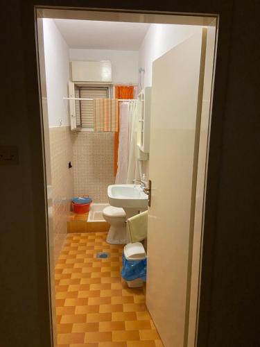 a bathroom with a toilet and a sink at Rooms Juran in Sukošan