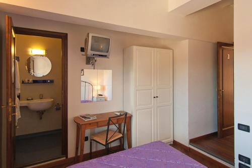 a bathroom with a sink and a table with a mirror at B&B Arco Antico in Florence