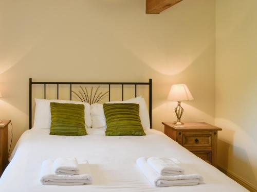 a bedroom with a bed with two towels on it at Grain Rooms - Uk3162 in Lucker