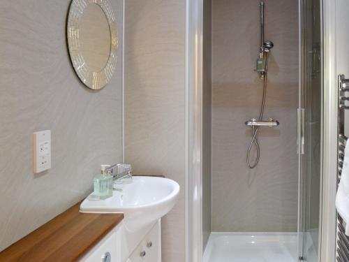 a bathroom with a sink and a shower at Grain Rooms - Uk3162 in Lucker
