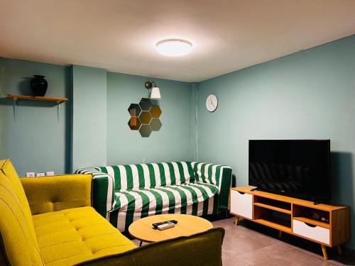 a living room with a couch and a tv at Lev Florentin Apartments in Tel Aviv