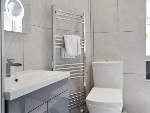 a bathroom with a white toilet and a sink at Belfrey House in York