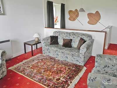 a living room with a couch and a rug at Upper Tower - 15458 in Cladich