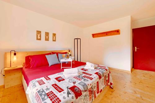 a bedroom with a red bed and a red door at Chalet 5 stars in San Bernardino, SKI SLOPES AND HIKING, Fireplace, 4 Snowtubes Free, Wi-Fi Free, for 8 persons, Wonderful in all seasons -By EasyLife Swiss in San Bernardino