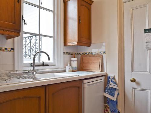 a kitchen with a sink and a window at Riverside in Alcester