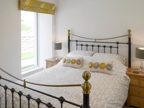 a bedroom with a large bed and a window at The Barn in Ankerville