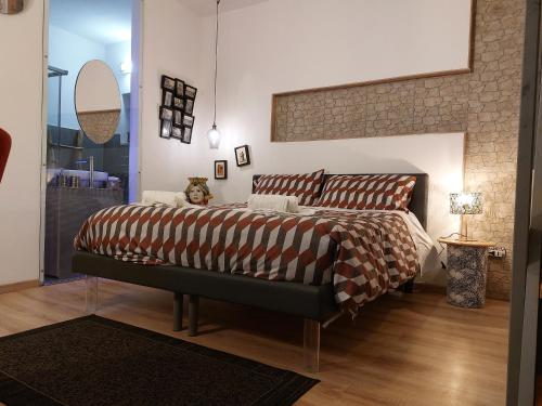 ein Schlafzimmer mit einem Bett und einer Ziegelwand in der Unterkunft Galena Charme Luxury Terrace in Syrakus