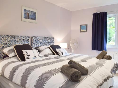 a bedroom with a large bed with towels on it at Little Croxley in Wroxall