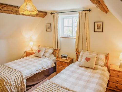 a bedroom with two beds and a window at East Granary - 28956 in Eye