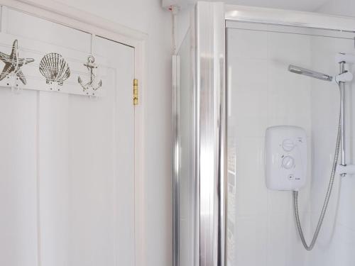 a shower in a bathroom with a glass door at Little Lismoy in Sandown