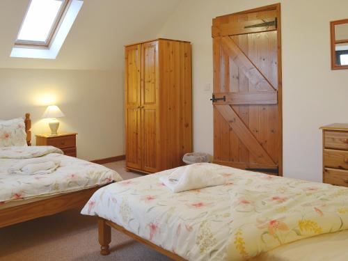a bedroom with two beds and a barn door at Ger Yllan in Cross Inn
