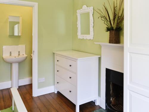 a bathroom with a sink and a white dresser at Craven House in West Burton
