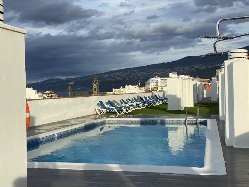 a swimming pool on the roof of a building at Apartamento Girasol in Puerto de la Cruz