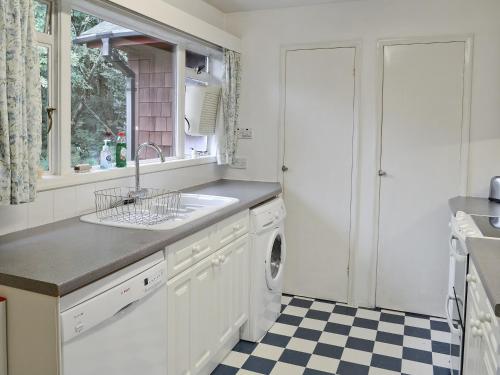 a kitchen with a sink and a dishwasher at Camus Na Harry in Shieldaig