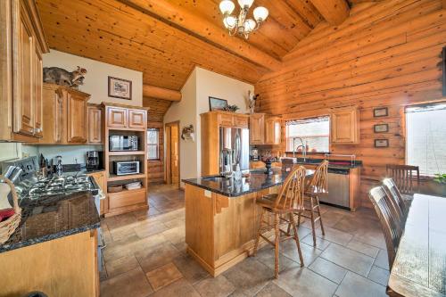 a kitchen with wooden walls and a wooden ceiling at Walk to Table Rock Lake Spacious Home with Deck! in Shell Knob
