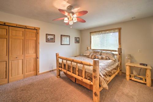 a bedroom with a bed and a ceiling fan at Walk to Table Rock Lake Spacious Home with Deck! in Shell Knob