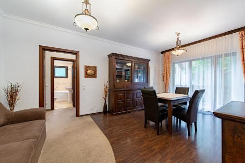 a living room with a table and chairs and a couch at Hotel Regal in Sinaia